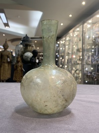 A Roman glass bottle with a conical neck, 4/5th C.