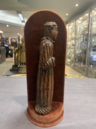 Two carved wooden Corpi Christi and a figure of a monk, Spain and Goa, 16th C.
