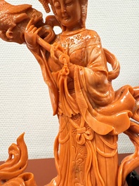 A Chinese red coral female deity holding a fan, 19/20th C.