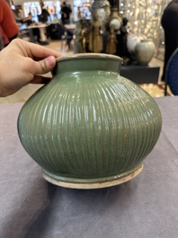 A Chinese Longquan celadon 'lotus' bowl and a large green-glazed jar, Ming and later