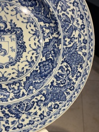 A large Chinese blue and white armorial dish with the arms of the Coelho family, Kangxi