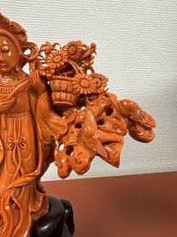 A Chinese red coral group of goddesses on wooden stand, 19/20th C.