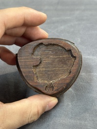 A Chinese jade peach-shaped brush washer on wooden stand, 19th C.