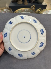 A pair of Chinese lotus-shaped blue and white plates with floral design, yu mark, Kangxi