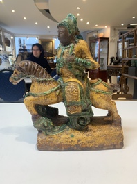 A pair of Chinese sancai-glazed rooftiles, a pair of Buddhist lions and a warrior, Ming and later