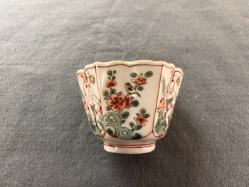 A fine Chinese famille verte 'boy and lotus' flower-shaped cup and a wooden stand, Kangxi