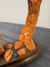 A Chinese pink-orange coral group of a goddess of spring, a wise man and children in a pine tree, 19/20th C.