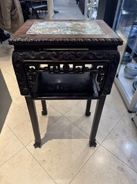 A pair of Chinese famille verte 'narrative' plaques mounted in hardwood tables, 19th C.
