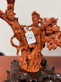 A Chinese red coral group of goddesses on wooden stand, 19/20th C.