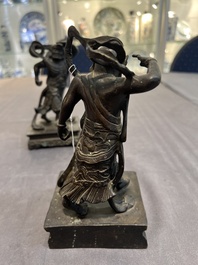 A pair of Chinese bronze guardians on stands, 17/18th C.