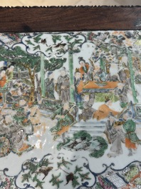 A pair of Chinese famille verte 'narrative' plaques mounted in hardwood tables, 19th C.