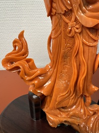 A Chinese red coral female deity holding a fan, 19/20th C.