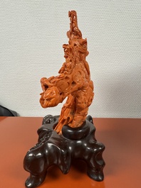 A Chinese red coral group of goddesses on wooden stand, 19/20th C.