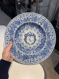 A large Chinese blue and white armorial dish with the arms of the Coelho family, Kangxi