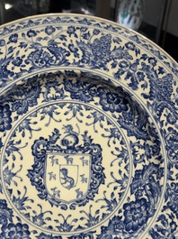 A large Chinese blue and white armorial dish with the arms of the Coelho family, Kangxi