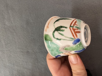 A Chinese famille verte ovoid tea caddy with floral design and a cup with figural design, Kangxi