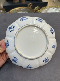 A pair of Chinese lotus-shaped blue and white plates with floral design, yu mark, Kangxi