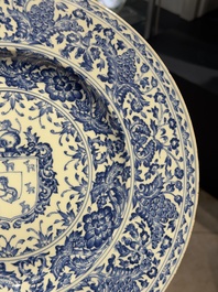 A large Chinese blue and white armorial dish with the arms of the Coelho family, Kangxi