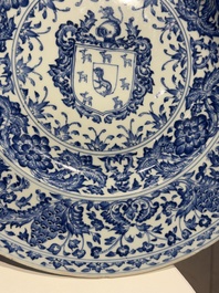 A large Chinese blue and white armorial dish with the arms of the Coelho family, Kangxi