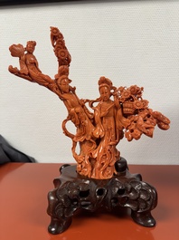 A Chinese red coral group of goddesses on wooden stand, 19/20th C.