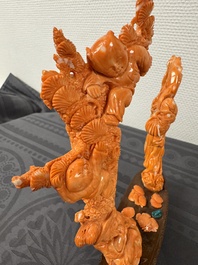 A Chinese pink-orange coral group of a goddess of spring, a wise man and children in a pine tree, 19/20th C.