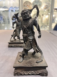 A pair of Chinese bronze guardians on stands, 17/18th C.