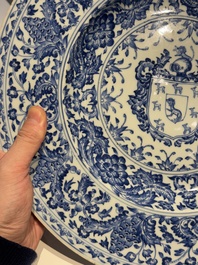 A large Chinese blue and white armorial dish with the arms of the Coelho family, Kangxi