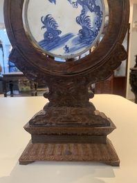 A Chinese blue and white 'Bleu de Hue' 'roosters and chick' plaque in a carved wooden screen and a bowl, 19th C.