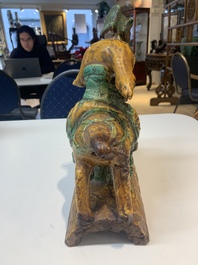 A pair of Chinese sancai-glazed rooftiles, a pair of Buddhist lions and a warrior, Ming and later