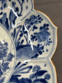 A pair of Chinese lotus-shaped blue and white plates with floral design, yu mark, Kangxi