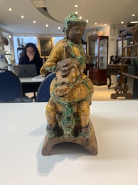 A pair of Chinese sancai-glazed rooftiles, a pair of Buddhist lions and a warrior, Ming and later