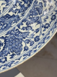 A large Chinese blue and white armorial dish with the arms of the Coelho family, Kangxi