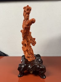A Chinese red coral group of goddesses on wooden stand, 19/20th C.