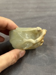 A Chinese jade peach-shaped brush washer on wooden stand, 19th C.