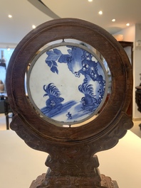 A Chinese blue and white 'Bleu de Hue' 'roosters and chick' plaque in a carved wooden screen and a bowl, 19th C.