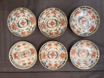 A set of 12 Chinese famille verte cups and saucers with floral design, Kangxi