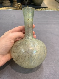 A Roman glass bottle with a conical neck, 4/5th C.