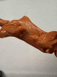 A Chinese red coral female deity holding a fan, 19/20th C.