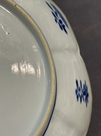 A pair of Chinese lotus-shaped blue and white plates with floral design, yu mark, Kangxi