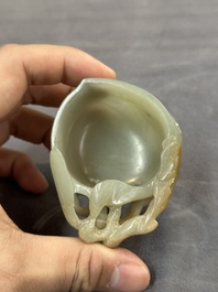 A Chinese jade peach-shaped brush washer on wooden stand, 19th C.