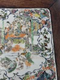 A pair of Chinese famille verte 'narrative' plaques mounted in hardwood tables, 19th C.