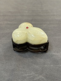 A Chinese Mughal-style leaf-shaped ruby-inset jade box and cover on wooden base, 18th C.