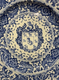 A large Chinese blue and white armorial dish with the arms of the Coelho family, Kangxi
