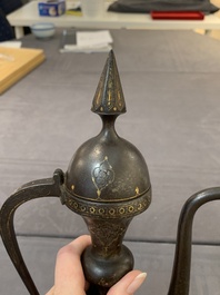 A Persian steel engraved gilt-decorated pear-shaped ewer and cover with floral design, Qajar, 19th C.