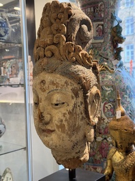 A large Chinese polychromed wooden head of Guanyin, probably Ming