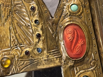 Alfred Daguet (Paris, 1875-1942): A Gothic Revival repouss&eacute; brass and copper-mounted mirror with glass cabochons, signed and dated 1907
