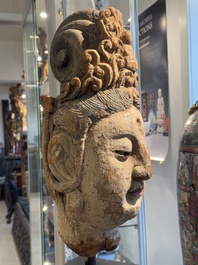 A large Chinese polychromed wooden head of Guanyin, probably Ming