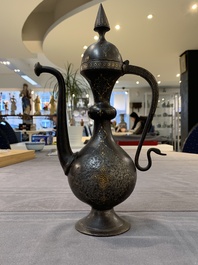 A Persian steel engraved gilt-decorated pear-shaped ewer and cover with floral design, Qajar, 19th C.