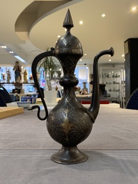 A Persian steel engraved gilt-decorated pear-shaped ewer and cover with floral design, Qajar, 19th C.