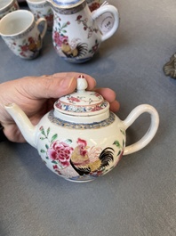 Two Chinese famille rose 'rooster' teapots, a milk jug and four handled cups, Yongzheng